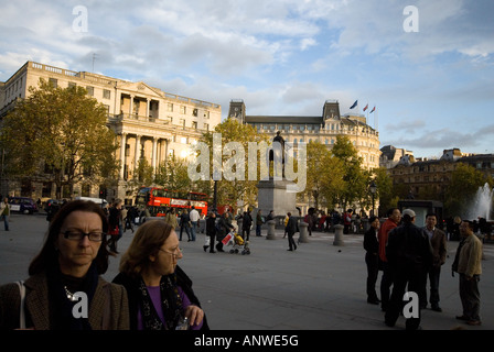 two woman with glasses walk in Trafalgar Square London Stock Photo