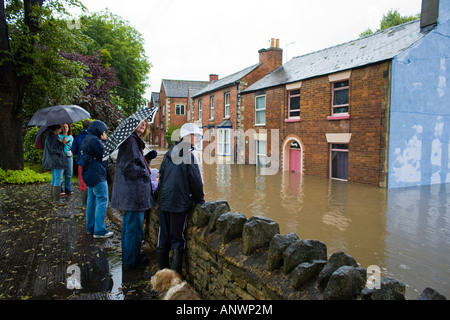 Bystanders look on at flooding on Slad Road in Stroud July 2007 Stock Photo