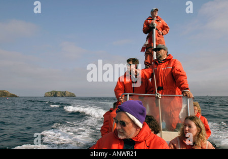 A zodiac full of people on a whale watching trip in Trinity Bay Bonavista Peninsula Newfoundland Canada Stock Photo