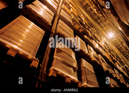Shrink wrapped product stacked on pallette awaiting distribution in fully automated modern high bay warehouse Stock Photo