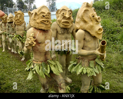 men with clay maskt at the Highland festival, Papua New Guinea Stock Photo