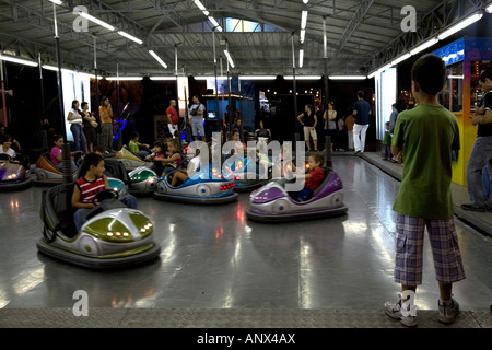 Boy Watching Dodgem Cars at Funfair Nettuno Park Catania Sicliy Italy Stock Photo