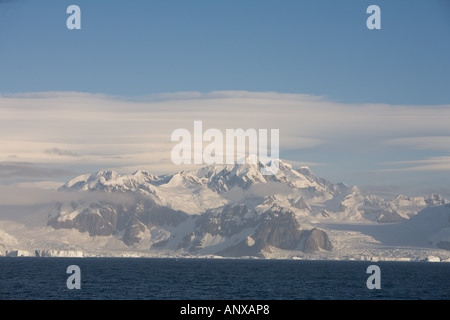 Unnamed peaks on the west coast of the Antarctic Peninsula in Grabam Land tower over the harsh Antarctic Coast Stock Photo