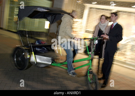 Couple on a Friday Night out in the West end of London Model released rickshaw Stock Photo