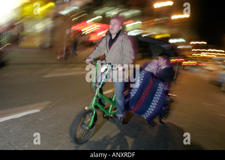 Couple on a Friday Night out in the West end of London Model released rickshaw Stock Photo