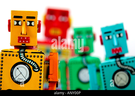 4 Chinese manufactured tinplate clockwork toy robots looking into camera Stock Photo
