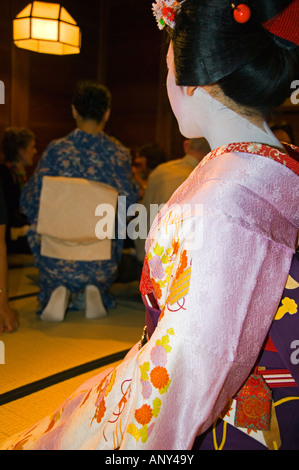 Japan, Honshu Island, Kyoto Prefecture, Kyoto City. Maiko (Trainee Geisha) entertainment at a formal dinner banquet. Stock Photo