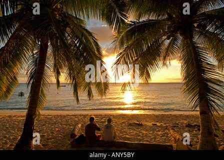 South Pacific, Fiji, Kadavu. Conservation volunteers watching the sunset. Stock Photo