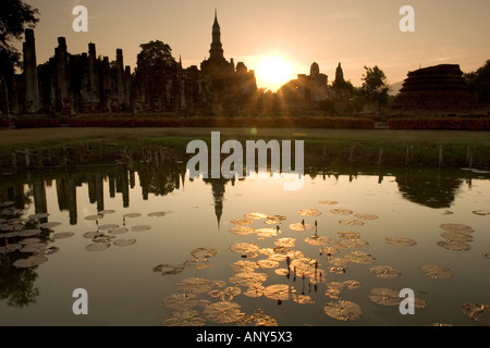 Thailand, Sukhothai ruins and sunset reflected in lotus pond Stock Photo
