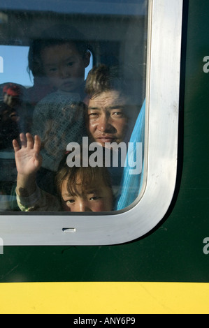 Steward welcomes passengers on board the Tangula Express / Sky Train, from Golmud, Qinghai province, China, to Lhasa, Tibet Stock Photo