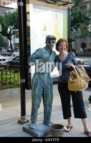 ILLINOIS Chicago Adult woman pose with male street performer make up to look like statue on Michigan Avenue Stock Photo