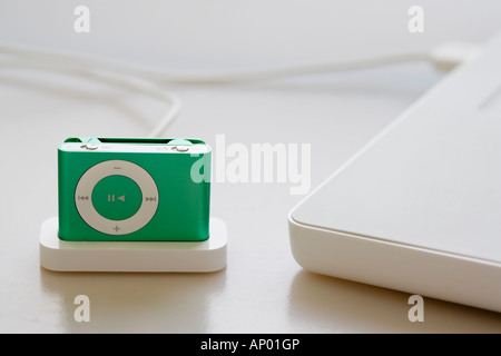 GREEN IPOD SHUFFLE CONNECTED TO LAPTOP COMPUTER Stock Photo