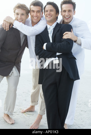 Groom with friends on beach Stock Photo