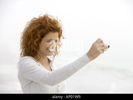 Woman using digital camera Stock Photo