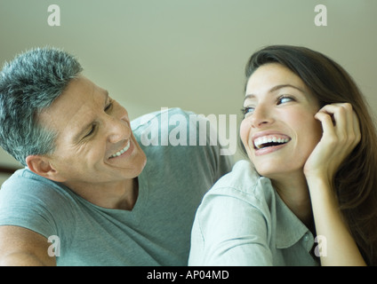 Couple smiling at each other, head and shoulders Stock Photo