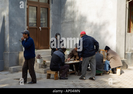 men playing a Chinese Chess board game in a local neighbourhood Hutong Beijing China Stock Photo