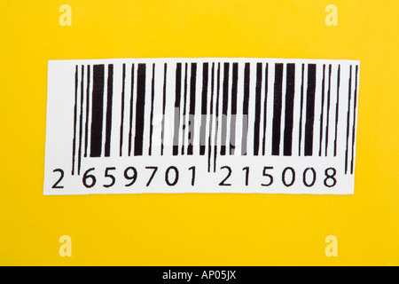 Barcode label with bar code numbers on a yellow background in close-up. An example of information technology. England, UK, Britain Stock Photo