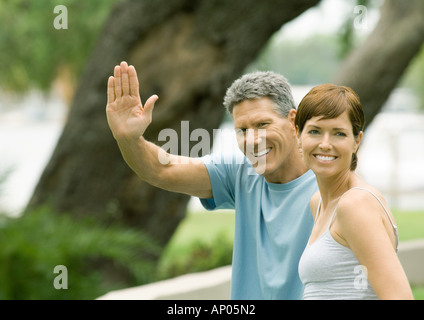 Mature couple, man waving Stock Photo