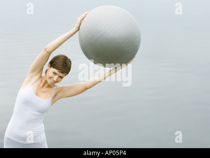 Woman working out with fitness ball Stock Photo
