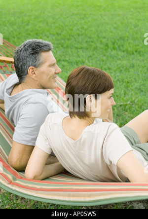 Couple lounging in hammock Stock Photo