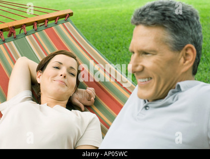 Couple lounging in hammock Stock Photo