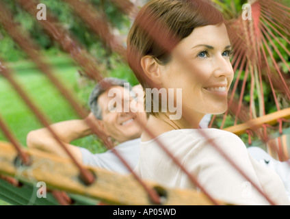 Couple lounging in hammock Stock Photo