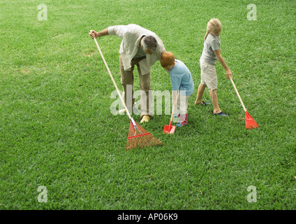 Father and children working in the yard Stock Photo