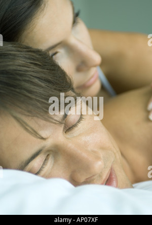 Couple lying in bed together Stock Photo