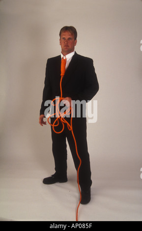 Necktie party going to work with a noose around your neck man tied up and in danger from himself suicide self abuse Stock Photo