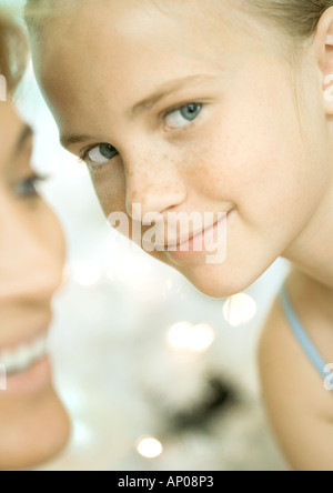Girl sideways to camera and woman in greenhouse Stock Photo - Alamy