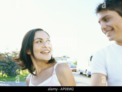 Young couple going for walk in residential neighborhood Stock Photo