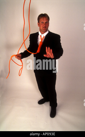 Necktie party going to work with a noose around your neck man tied up and in danger from himself suicide self abuse Stock Photo
