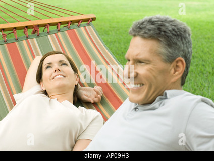 Mature couple lounging in hammock Stock Photo