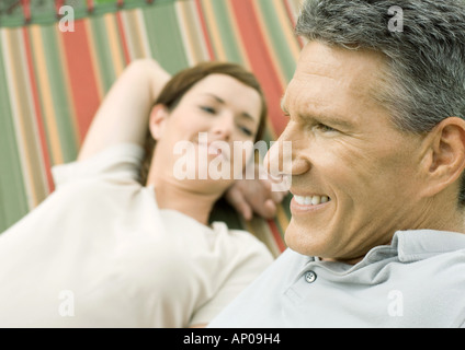 Mature couple lounging in hammock Stock Photo