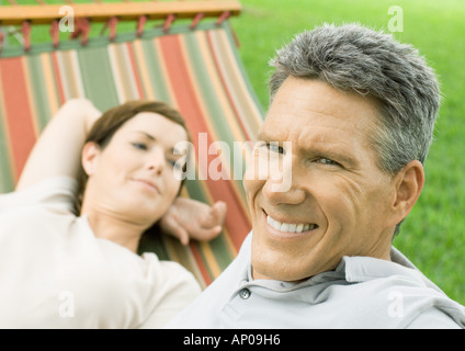 Mature couple lounging in hammock Stock Photo