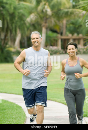 Couple jogging in park Stock Photo