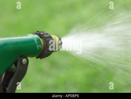 Water spraying from garden hose Stock Photo