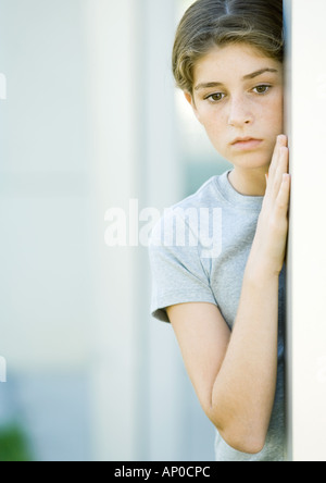 Girl leaning against wall Stock Photo