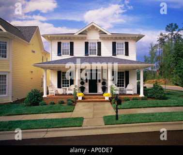 Small Two Story White House With Black Shutters Brick Porch Stock Photo