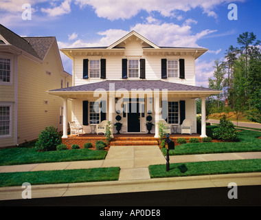 Small Two Story White House With Black Shutters Brick Porch Stock Photo