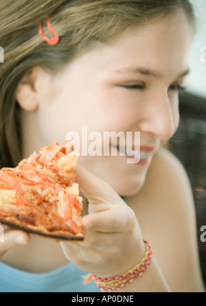 Girl holding slice of pizza Stock Photo