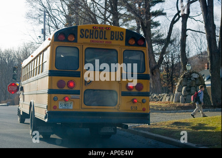 Child getting off a school bus Stock Photo