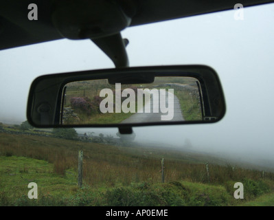 concept image of car on loenly country lane Stock Photo