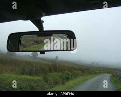 concept image of car on loenly country lane Stock Photo