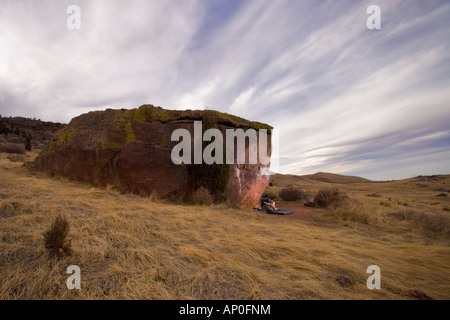 Male rock climber resting between tries on a boulder problem in Colorado Stock Photo