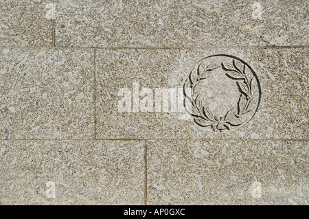 grey granite wall with carved laurel leaves Stock Photo