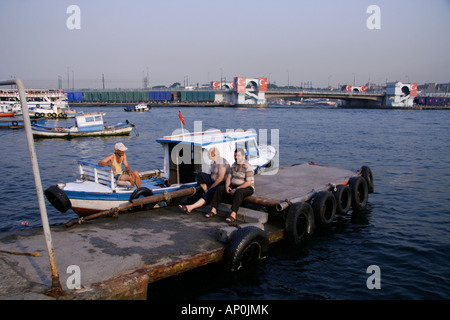 men enjoying their freetime on their little fishing boat istanbul harbour turkey Stock Photo