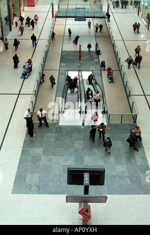 Arndale centre Manchester concourse walkway escalator pedestrian shopper consumer entertainment home virtual reality  techno dig Stock Photo