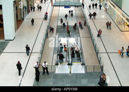 Arndale centre Manchester concourse walkway escalator pedestrian shopper consumer entertainment home virtual reality  techno dig Stock Photo