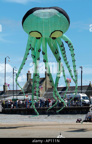 kite festival green octopus suckers arm leg tentacle huge geometric blue sky multi colour color morcambe Lancashire north west U Stock Photo